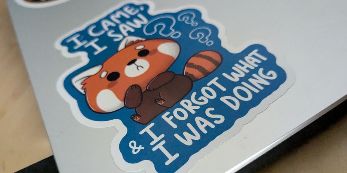 Photo of a sticker on my laptop's lid, showing a confused red panda and saying "I came, I saw, I forgot what I was doing"