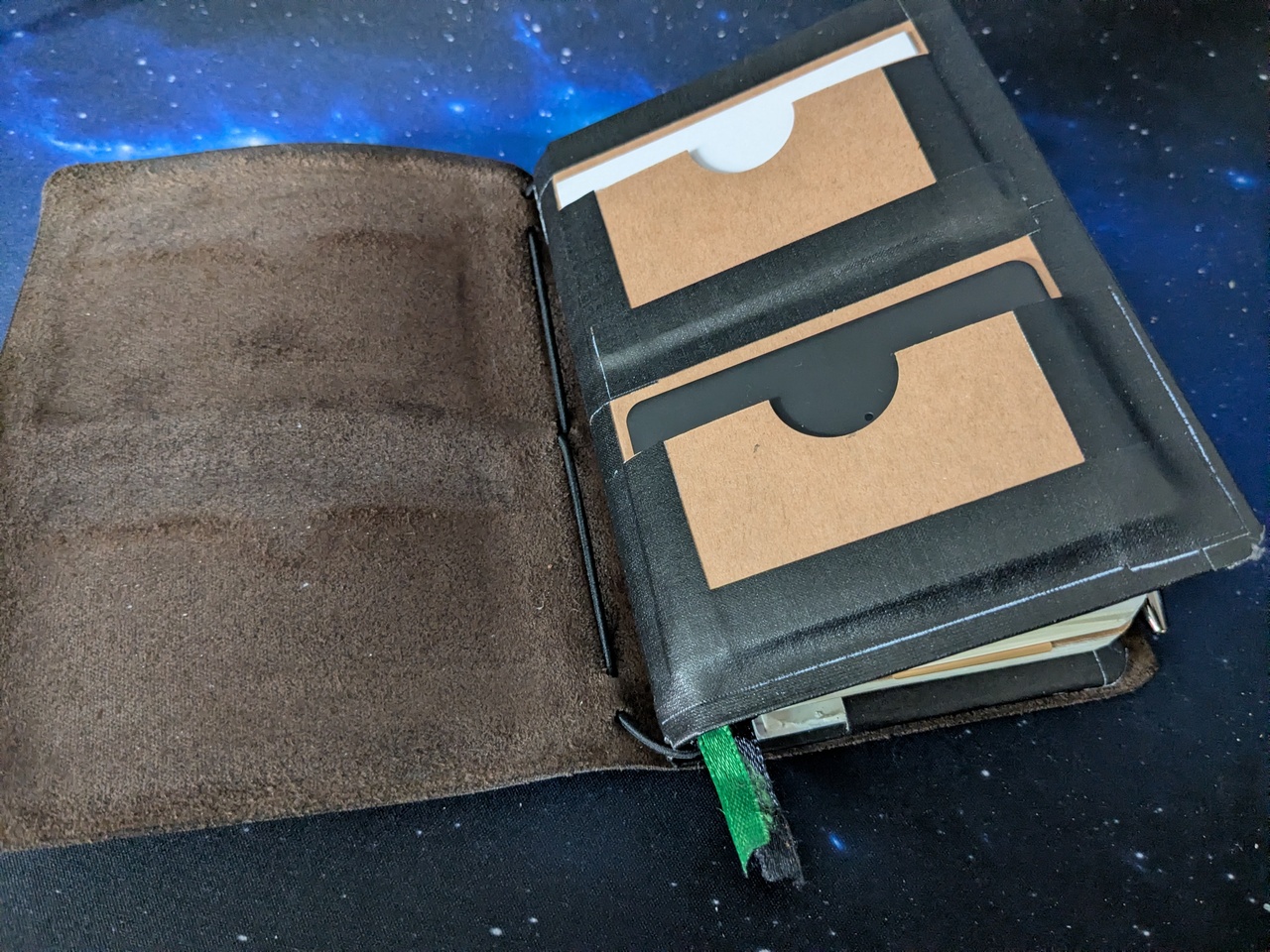 The outside front of the insert, with two card holders. The top one holds some white cards, the bottom one a black card sized tracker.