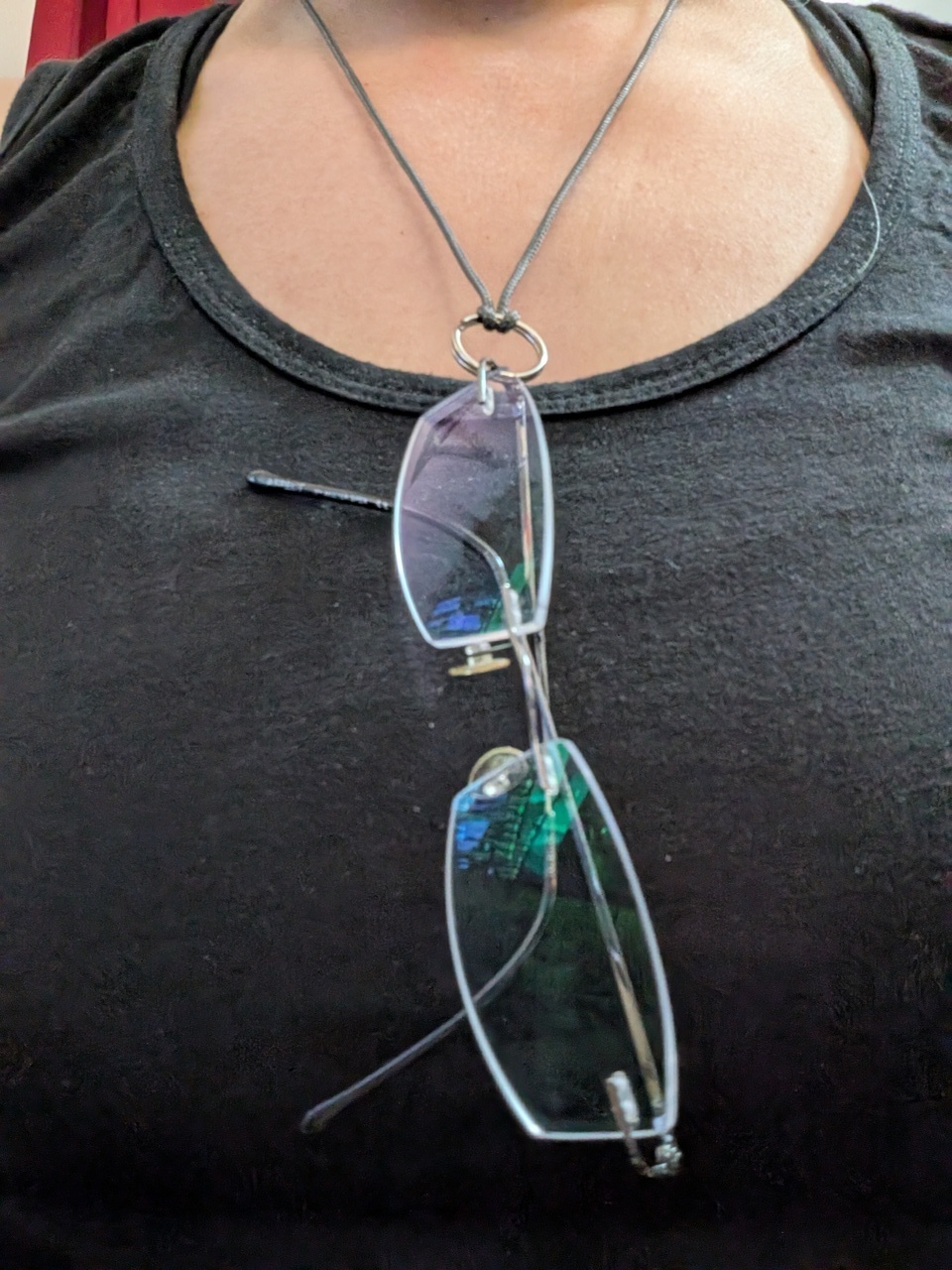 The holder around my neck, my regular glasses hooked onto it