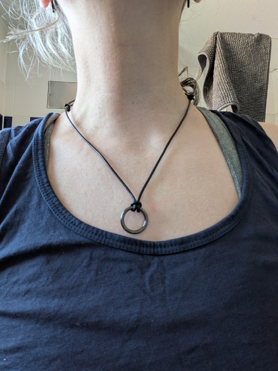 The second holder around my neck: a black leather cord and a dark metal o-ring.